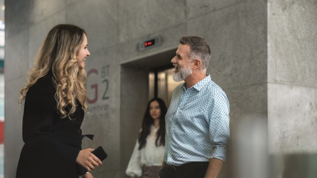 Two employees talking in the lobby