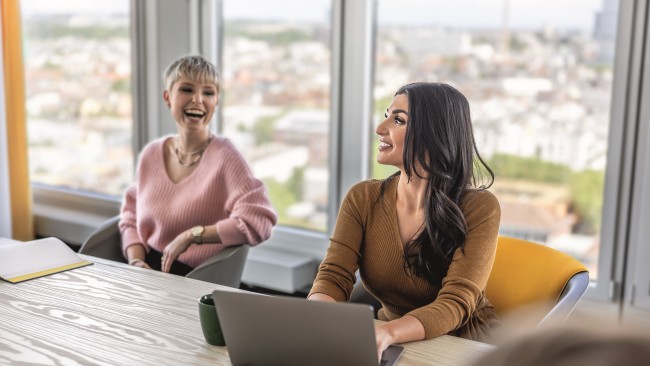 Two employees sitting in a conference room