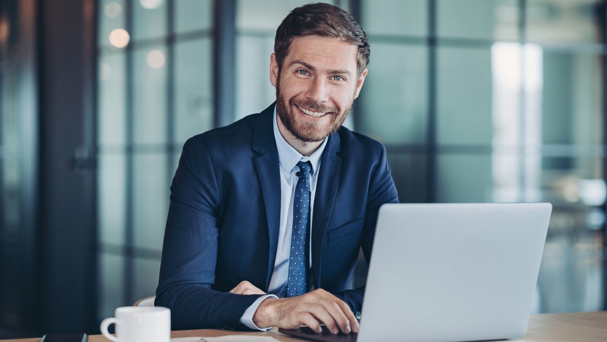 Youngman at desk with laptop